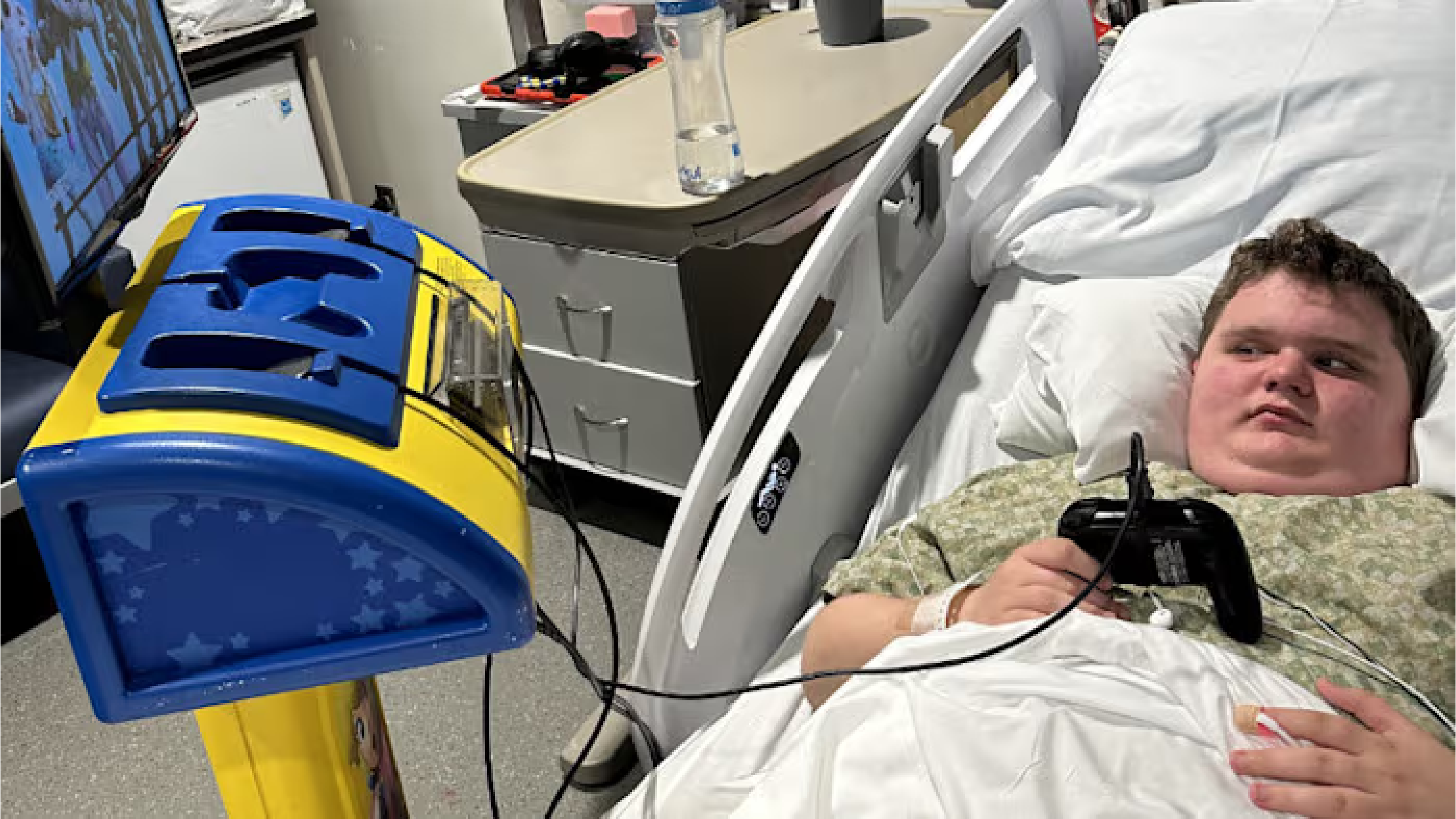 Patrick in hospital bed playing video games