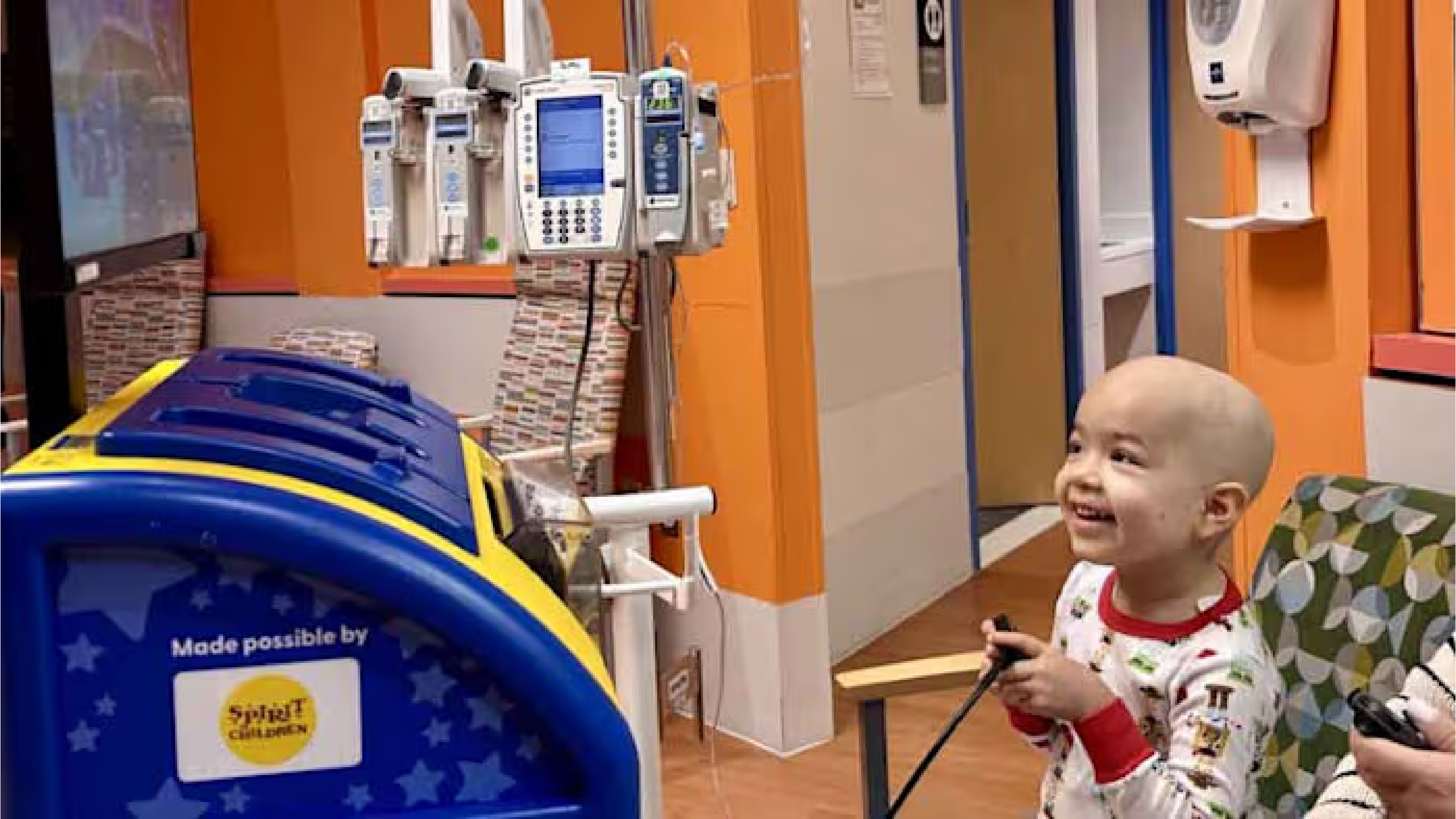 Sophia smiling and playing video games in hospital